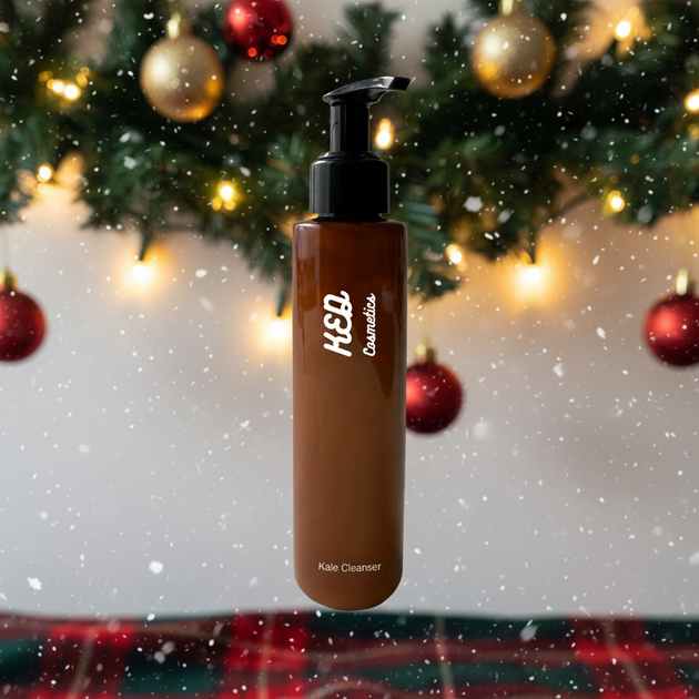 Kale Face Cleanser in a brown pump bottle with a festive background of lights and snow.